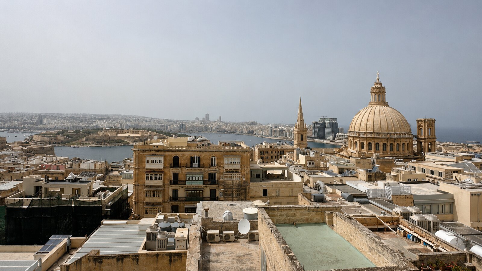 View across Valletta’s rooftops towards the Carmelite church dome and harbour